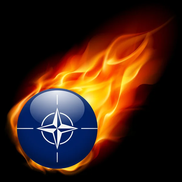 Bandiera della NATO come icona rotonda lucida che brucia in fiamme — Vettoriale Stock