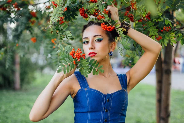 Beautiful young woman with rowan berries — Stock Photo, Image