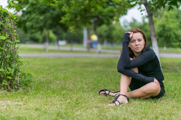 Woman sitting on the grass in park