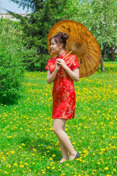 Güzel Asyalı kız geleneksel Çince kırmızı elbise ile bambu şemsiye. — Stok fotoğraf