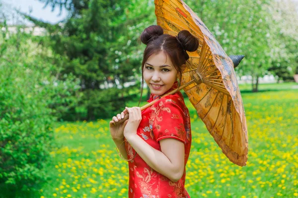 Hermosa chica asiática en vestido rojo chino tradicional con paraguas de bambú . —  Fotos de Stock