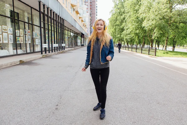 Girl listening to music streaming with headphones.