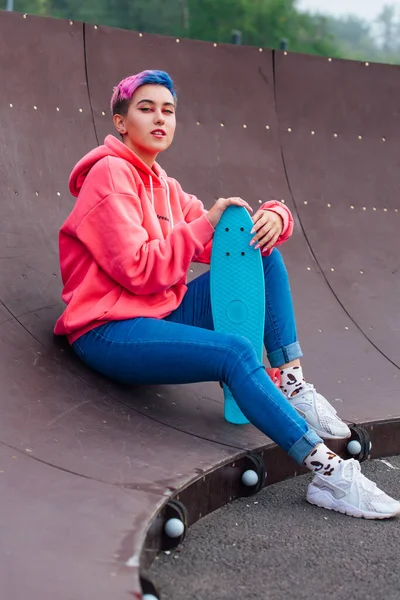 Mavi Plastik Kaykayıyla Parka Oturan Kısa Boylu Şık Bir Genç — Stok fotoğraf