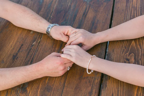Two pairs of hands holding each other. — Stock Photo, Image