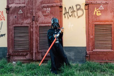 Çocuk bir kostüm Darth Vader kılıç ile.