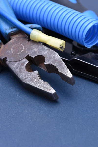 Pliers and cables on surface — Stock Photo, Image