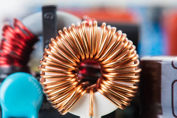 Electromagnetic Inductor copper wire winding on circuit board close-up