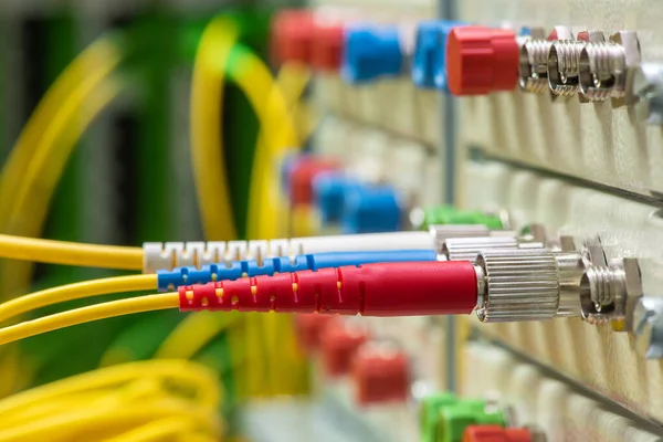 Fiber Optical Network Cables Connected to Patch Panel in Communication Data Center