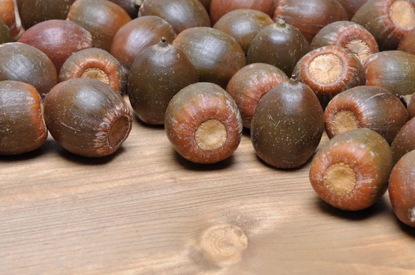 Brown acorns on board — Stock Photo, Image