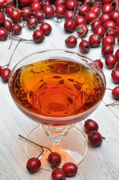 Glass of  hawthorn liqueur and hawthorn fruit — Stock Photo, Image