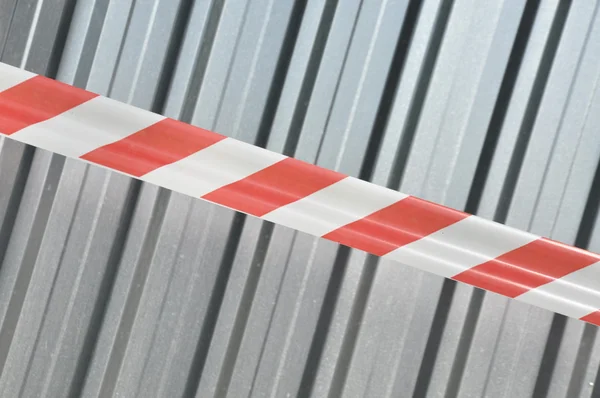 Warning tape with corrugated sheet — Stock Photo, Image