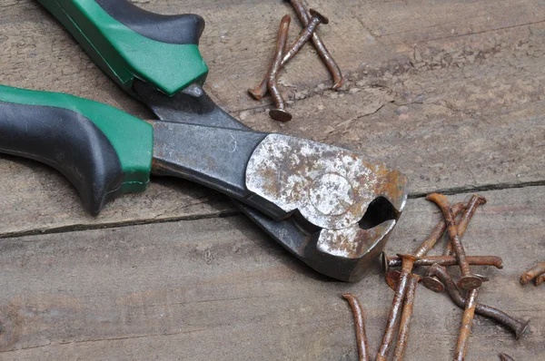 Rusty pliers with nail — Stock Photo, Image