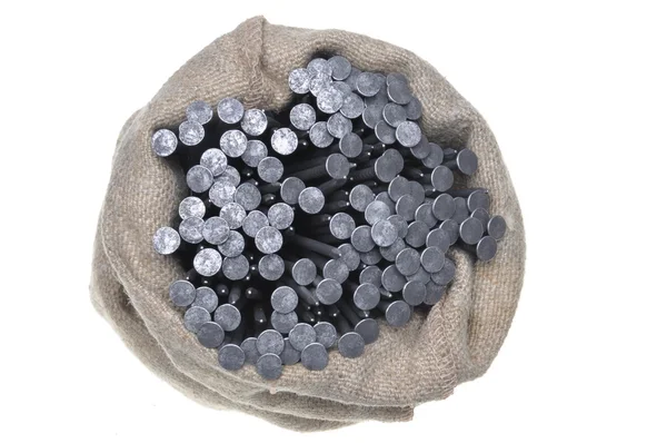Clavos de metal en una bolsa de lino — Foto de Stock
