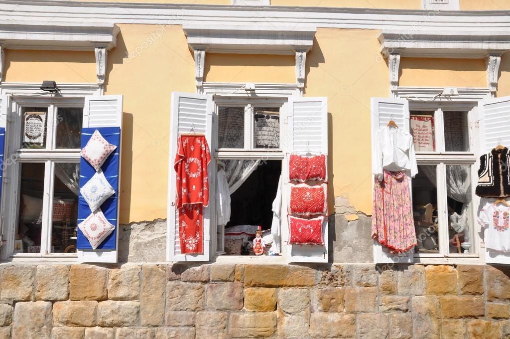 Windows of an old building in Szentendre Hungary with exposed folk handicrafts