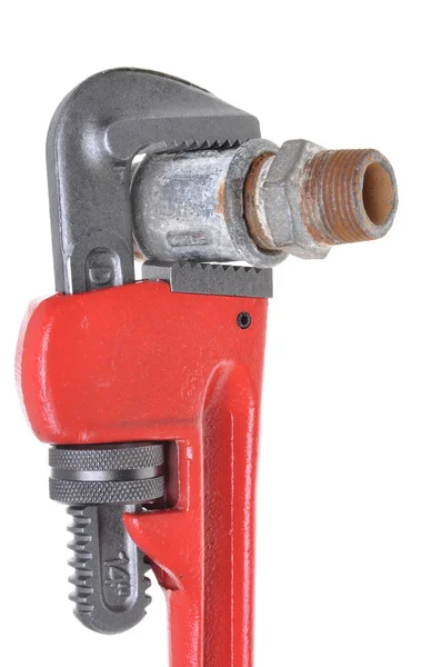 Red plumbers pipe wrench and plumbing component — Stock Photo, Image