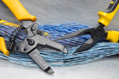 Crimping tool pliers and cables on grey background clipart