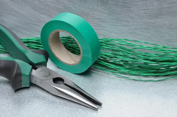 Outils et câbles électriques verts sur la surface métallique — Photo