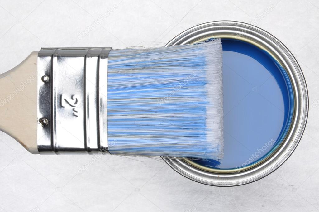 Top view of blue paint can with brush