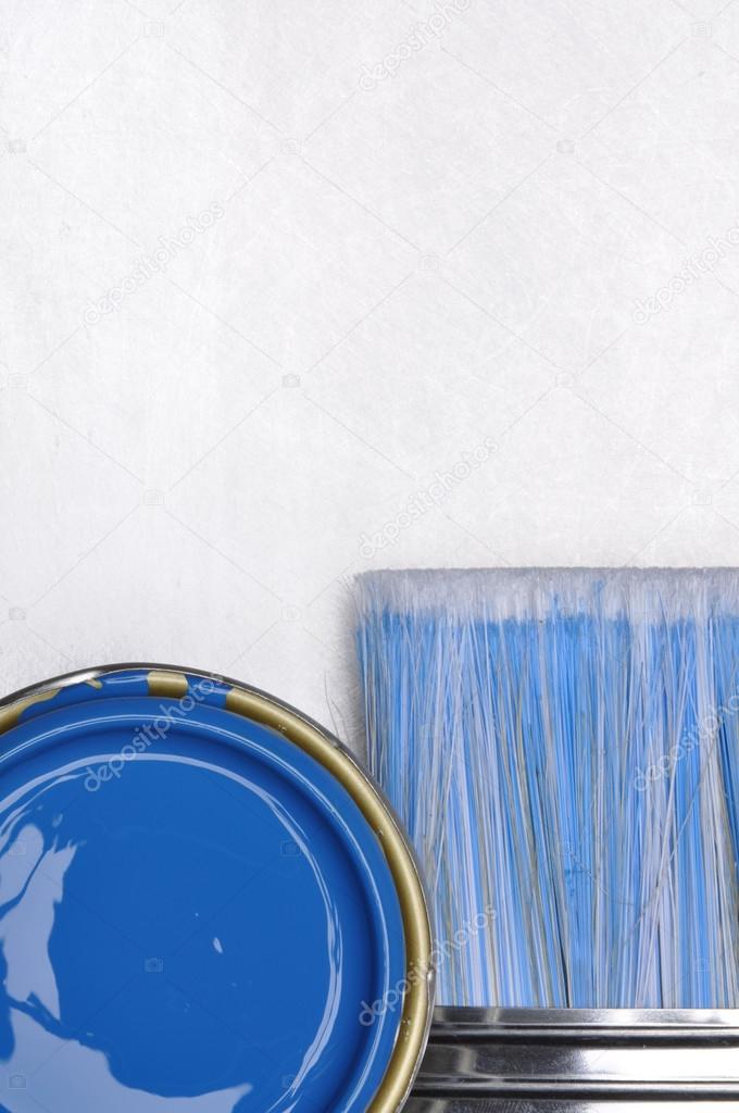 Top view of blue paint can with brush