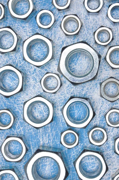 青い金属背景のスチール ナット — ストック写真
