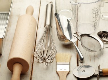 Kitchen baking utensils against white desk clipart
