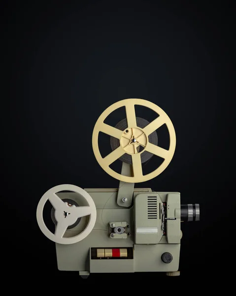 Vintage eight millimeters celluloid movie film projector on black background. Path included.