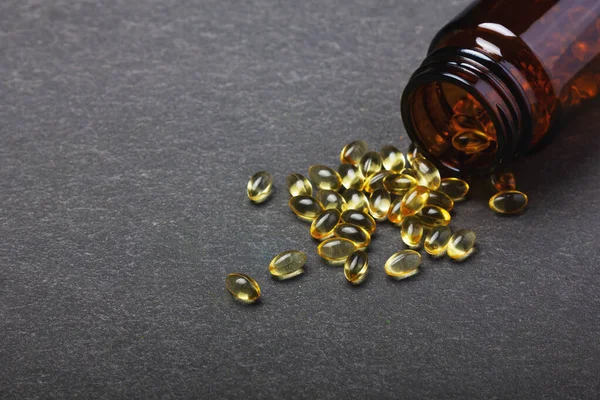 Vitamin Bottle Spilled Contents Black Background — Stock Photo, Image