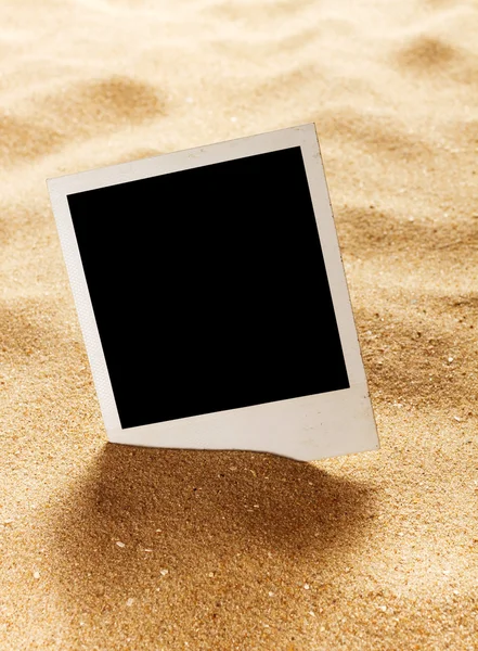 Old style empty photo cards lying on a sea sand. — Stock Photo, Image