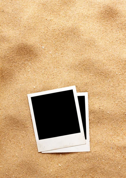 Old style empty photo cards lying on a sea sand. — Stock Photo, Image