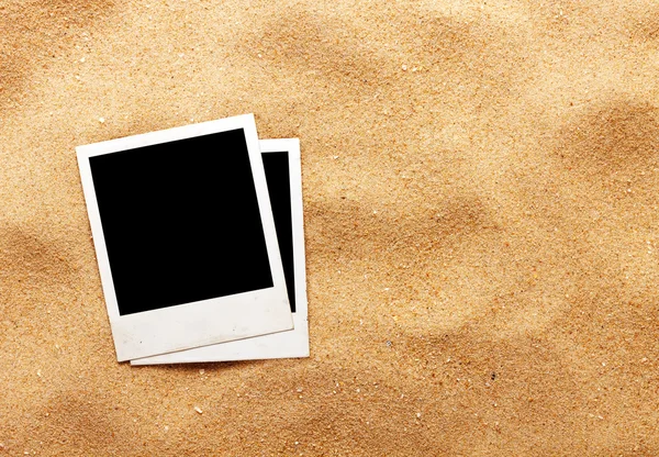 Old style empty photo cards lying on a sea sand. — Stock Photo, Image