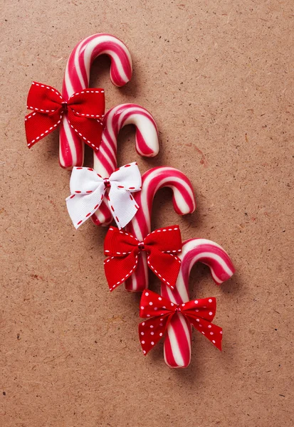 Candy canes on wooden board — Stock Photo, Image