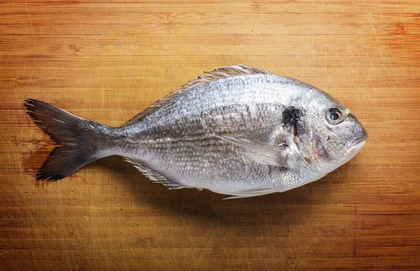 Fish on wooden background — Stock Photo, Image