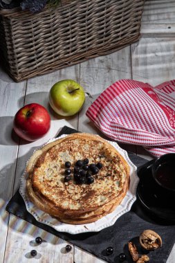 Kumaş arka planda krep, çay, krema ve meyveler