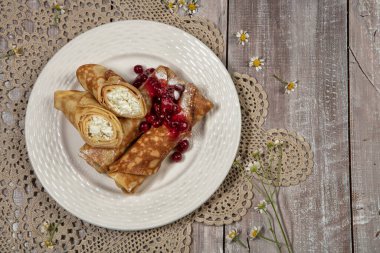 Eski ahşap bir arka planda etli gözleme ve bir fincan çay.