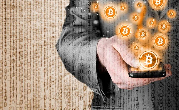 Hand with mobile smart phone and bitcoin symbol