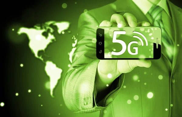 Businessman holding phone with 5G