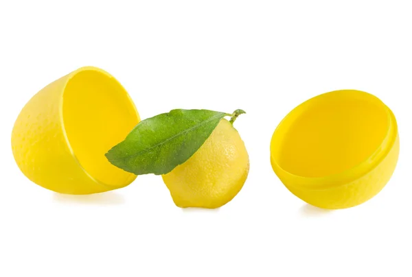 Lemon with green leaf and storage container on white. — Stock Photo, Image