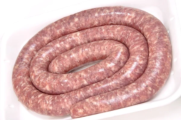 Raw sausage on tray. — Stock Photo, Image
