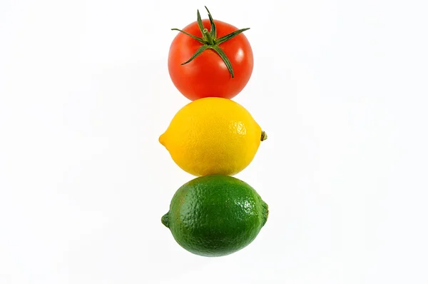 Tomato, lemon and lime on white. — Stock Photo, Image