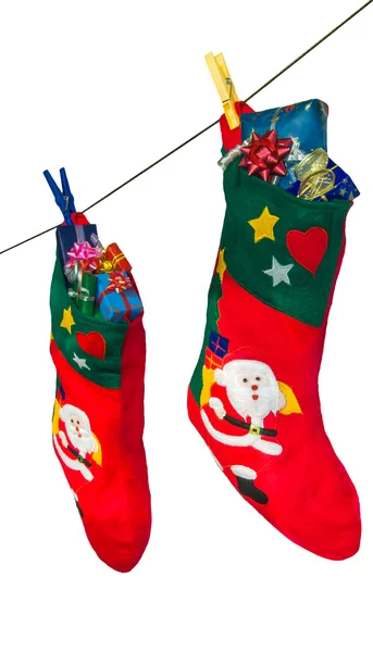 Christmas stockings and gifts hanging on the rope. — Stock Photo, Image