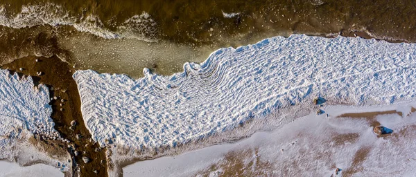 Aerial view over partialy frozen sea with white ice texture — Stock Photo, Image