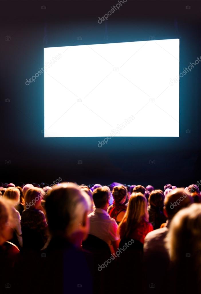 Crowd audience looking at screen