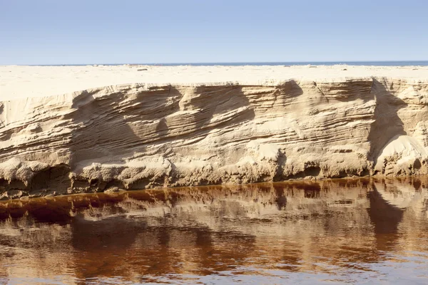 Eroded sand riverbank — Stock Photo, Image