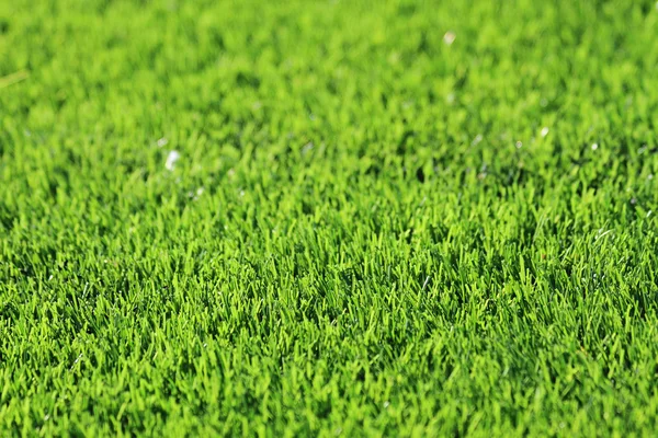 Kunststof groen gras achtergrond — Stockfoto