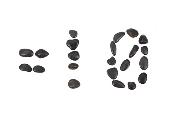 Каменный алфавит из черных камней — стоковое фото