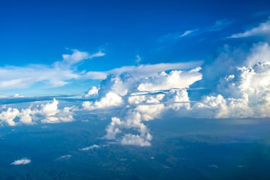Bulutlar ve gökyüzü bir uçağın penceresinden görüldüğü gibi