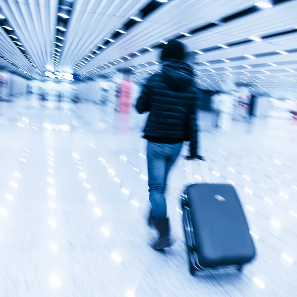 Passagerare i beijing airport, rörelseoskärpa Stockbild