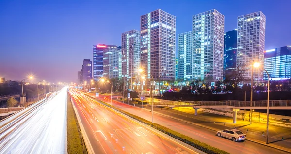 Senderos ligeros en la ciudad moderna al atardecer en beijing, China — Foto de Stock