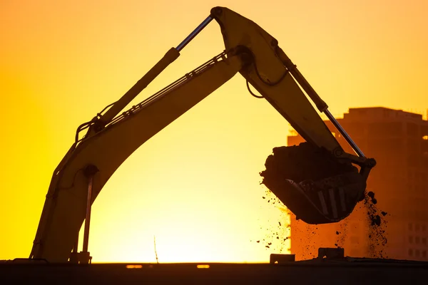 Closeup excavator at sunset — Stock Photo, Image