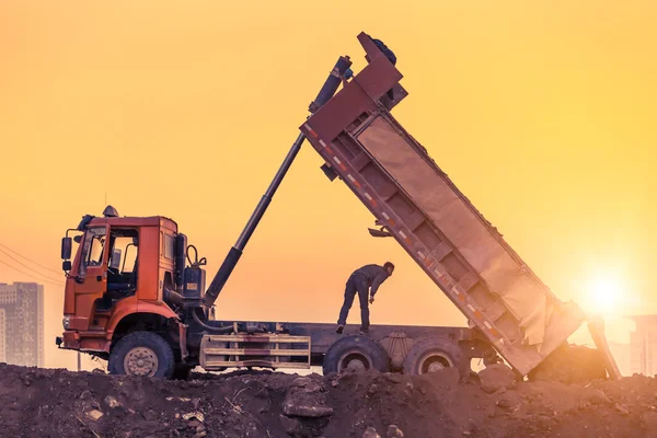 Heavy wheel loader machine working at sunset — Stock Photo, Image